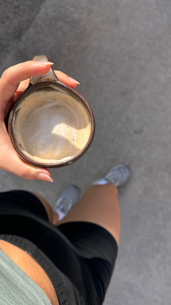 A mug of coffee in hand on a morning walk